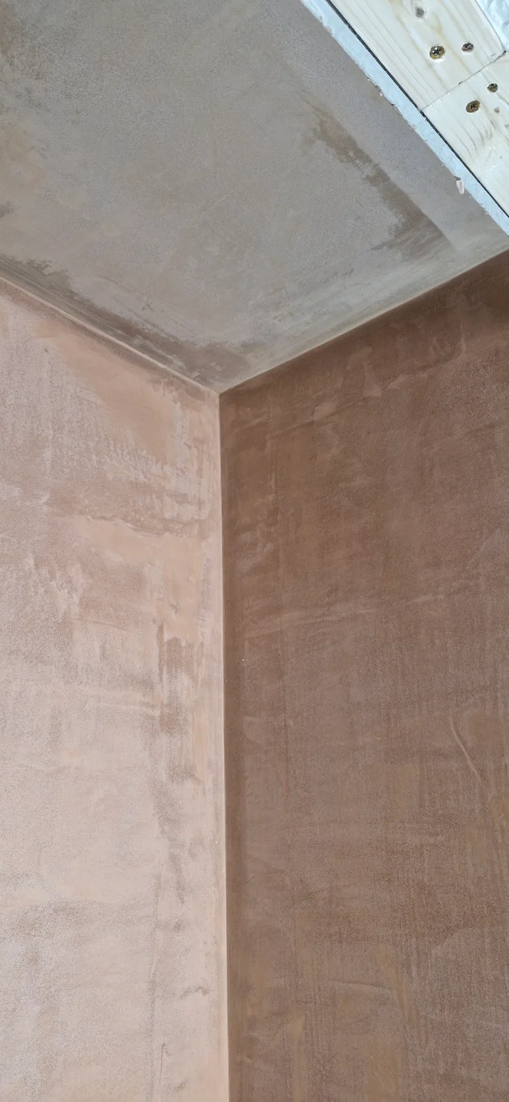 Tall plastered wall meeting the ceiling
